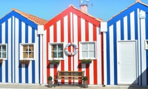 Row of vibrant striped houses in navy blue, red, and white with nautical charm